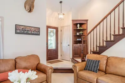 a living room with a couch and a staircase at Spring Mountain Cove in Warsaw
