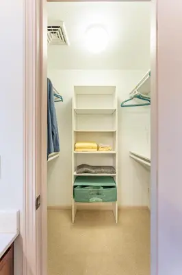 a walk in closet with white shelves at Spring Mountain Cove in Warsaw