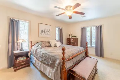 a bedroom with a bed and a ceiling fan at Spring Mountain Cove in Warsaw