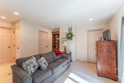 a living room with a couch and a tv at Spring Mountain Cove in Warsaw
