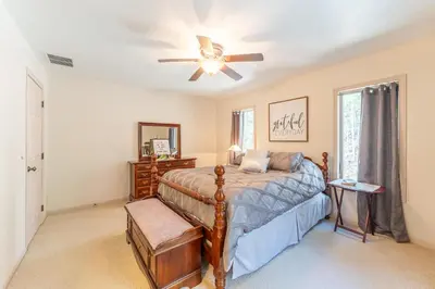 a bedroom with a bed and a ceiling fan at Spring Mountain Cove in Warsaw