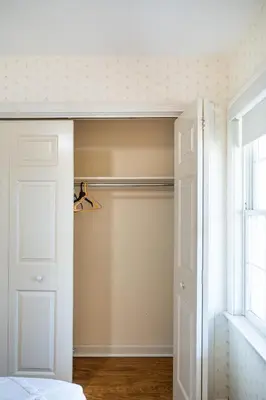 a closet with a white door and a window at Country Cottage in Apple Creek