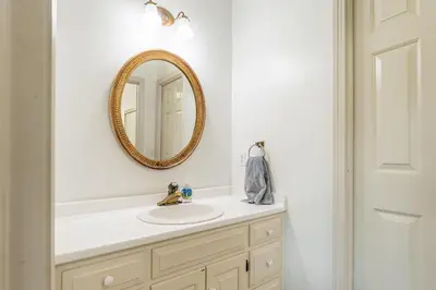 a bathroom with a sink and a mirror at Country Cottage in Apple Creek