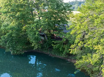 an aerial view of a house next to a river at White Oak Cottage in Mount Orab