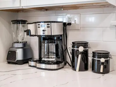 a kitchen counter with a coffee maker and a blender at Oakwood Charm Family-Friendly 3BR Getaway in Columbus