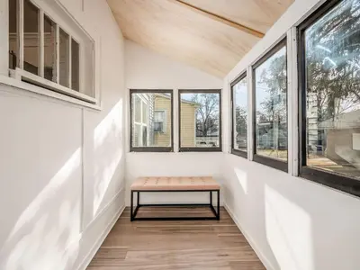 a bench in a hallway with windows at Oakwood Charm Family-Friendly 3BR Getaway in Columbus