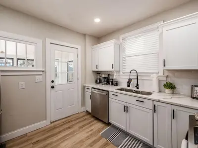 a kitchen with white cabinets and a sink at Oakwood Charm Family-Friendly 3BR Getaway in Columbus
