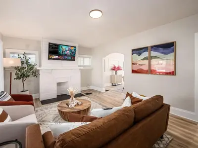 a living room with a couch and a fireplace at Oakwood Charm Family-Friendly 3BR Getaway in Columbus