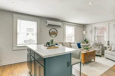 a kitchen with an island in the middle of a living room at 2 Mi to Ark Encounter Condo on Main Street! in Williamstown
