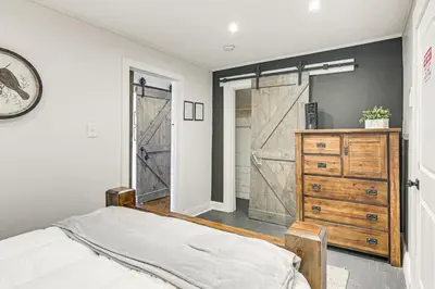 a bedroom with a bed and a dresser and a closet at 2 Mi to Ark Encounter Condo on Main Street! in Williamstown