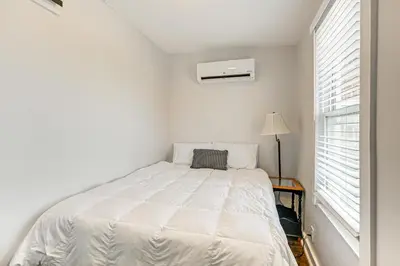 a white bedroom with a bed and a window at 2 Mi to Ark Encounter Condo on Main Street! in Williamstown