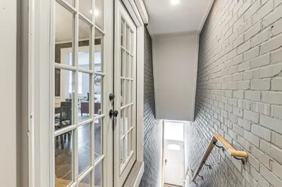 a hallway with a door and a brick wall at 2 Mi to Ark Encounter Condo on Main Street! in Williamstown