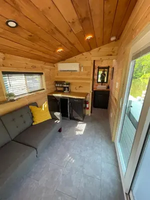 a living room of a tiny house with a couch at Floating Tiny Home #1 in Vermilion