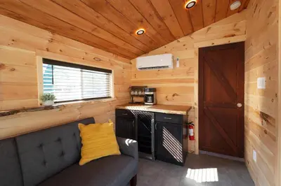 a kitchen with a couch in a tiny house at Floating Tiny Home #1 in Vermilion