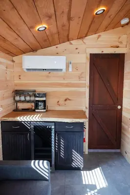 a kitchen in a tiny house with a door at Floating Tiny Home #1 in Vermilion