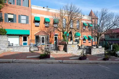 a brick building with green awnings on a street at Mt Adams Nest - Studio for 2 in Cincinnati