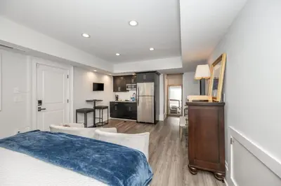 a bedroom with a bed and a living room with a kitchen at Mt Adams Nest - Studio for 2 in Cincinnati
