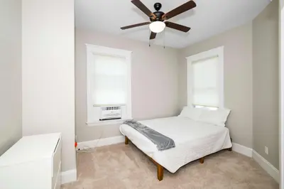 a bedroom with a bed and a ceiling fan at Ludlow Lodge with City Views in Ludlow
