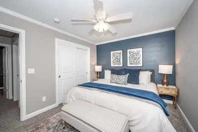 a bedroom with a bed and a ceiling fan at Ark Adventure Retreat in Walton