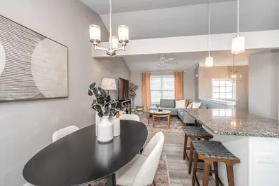 a kitchen and living room with a black table and chairs at Ark Adventure Retreat in Walton