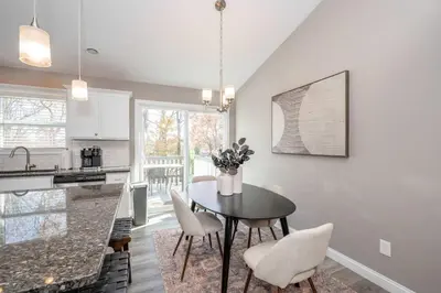 a kitchen and dining room with a table and chairs at Ark Adventure Retreat in Walton