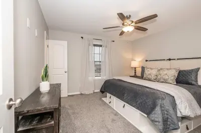 a bedroom with a bed and a ceiling fan at The Gem Vacation Rental in Walton