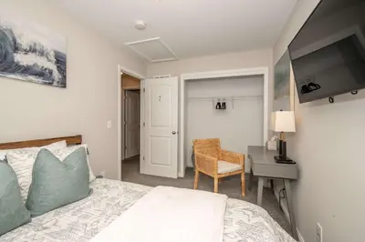 a bedroom with a bed and a desk and a chair at The Gem Vacation Rental in Walton