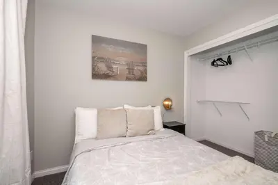 a bedroom with a bed and a picture on the wall at The Gem Vacation Rental in Walton