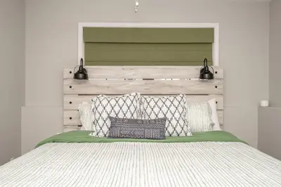 a bedroom with a large bed with two pillows at The Gem Vacation Rental in Walton