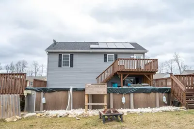 a house with solar panels on top of a fence at The Gem Vacation Rental in Walton