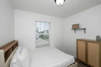 a white bedroom with a bed and a window at The Ark Encounter Retreat in Walton
