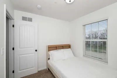 a white bedroom with a bed and a window at The Ark Encounter Retreat in Walton