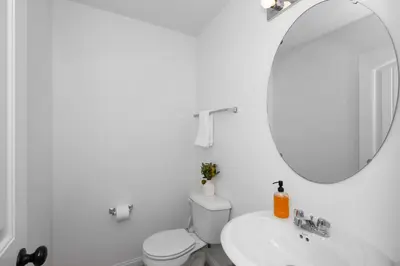 a white bathroom with a sink and a mirror at The Ark Encounter Retreat in Walton