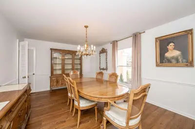 a dining room with a wooden table and chairs at Tallen Manor & Retreat in Hamilton