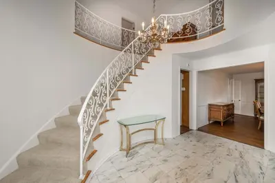 a staircase in a home with a glass table at Tallen Manor & Retreat in Hamilton