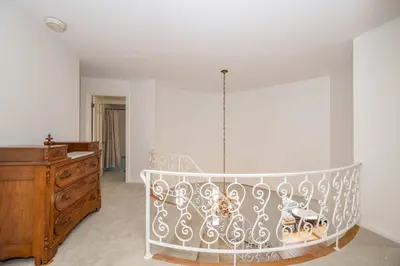 a room with a crib and a wooden dresser at Tallen Manor & Retreat in Hamilton