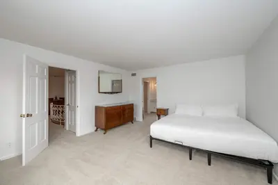 a bedroom with a bed and a dresser and a mirror at Tallen Manor & Retreat in Hamilton