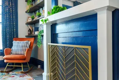 a blue garage door in a living room with a orange chair at Merion Village Residences 1164 in Columbus