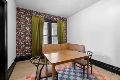 a dining room with a wooden table and chairs at Merion Village Residences 1166 in Columbus