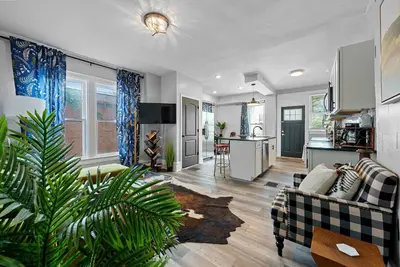 a living room with a couch and a kitchen at Merion Village Residences Suites in Columbus