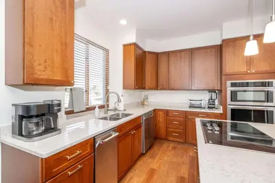 a kitchen with wooden cabinets and stainless steel appliances at Luxurious Dream Home - For 10 in Loveland