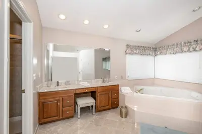 a bathroom with a tub and a large mirror at Luxurious Dream Home - For 10 in Loveland