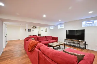 a living room with a red couch and a flat screen tv at Luxurious Dream Home - For 10 in Loveland