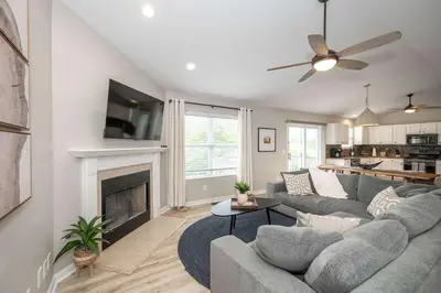 a living room with a couch and a fireplace at Poolside Paradise Near the Ark in Walton