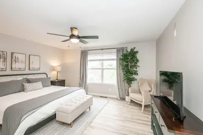 a bedroom with a bed and a ceiling fan at Poolside Paradise Near the Ark in Walton