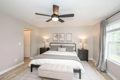 a bedroom with a bed and a ceiling fan at Poolside Paradise Near the Ark in Walton