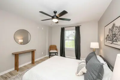 a bedroom with a bed and a ceiling fan at Poolside Paradise Near the Ark in Walton
