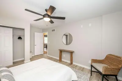 a bedroom with a bed and a ceiling fan at Poolside Paradise Near the Ark in Walton