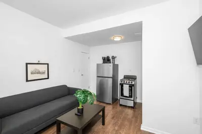 a living room with a couch and a refrigerator at Northside Suites 1 - Best Retreat for Couples in Cincinnati