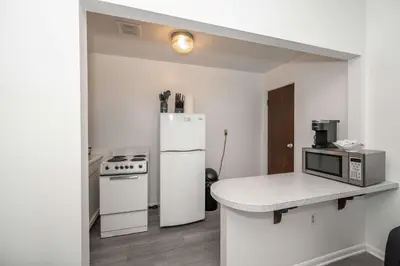 a kitchen with a white refrigerator and a microwave at Northside Suite 2 - Cozy Escape in Cincinnati